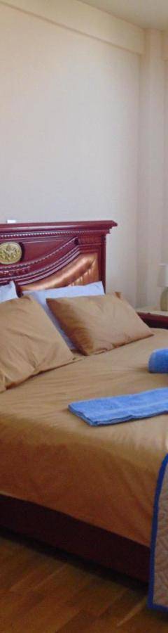 a bedroom with a bed with a blue towel on it at Ithaki Phinikoudes Apartments No. 106 in Larnaka