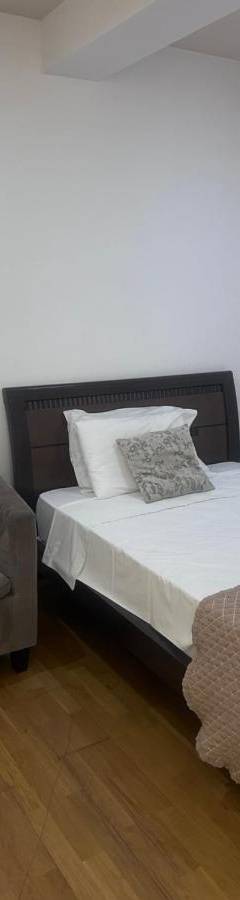 a bedroom with a bed and a chair at Ithaki Phinikoudes Apartments No. 106 in Larnaka