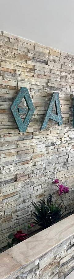a brick wall with a sign that reads exit at Ithaki Phinikoudes Apartments No. 106 in Larnaka