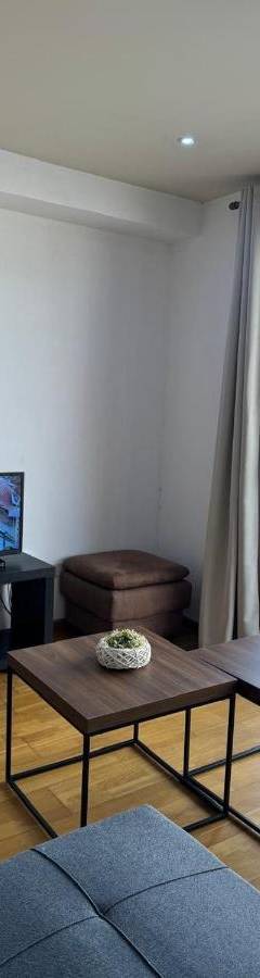 a living room with a couch and a tv at Ithaki Phinikoudes Apartments No. 106 in Larnaka