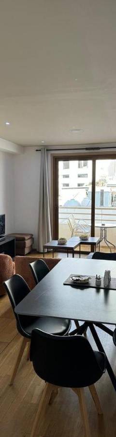 a living room with a table and chairs and a couch at Ithaki Phinikoudes Apartments No. 106 in Larnaka
