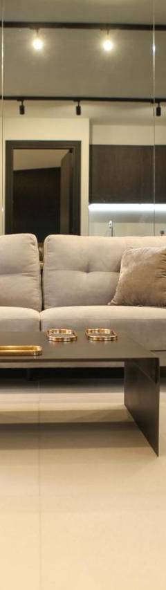 a living room with a couch and a table and chairs at Raam Luxury Suites in Larnaka