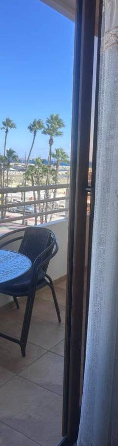 a balcony with a table and a view of the beach at Ithaki Phinikoudes Apartment No. 205 in Larnaka