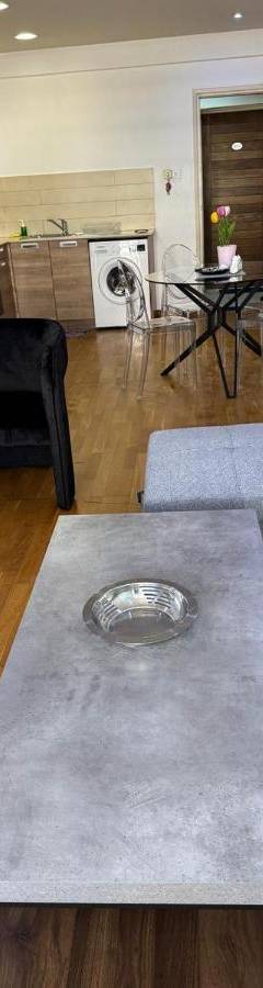 a living room with a couch and a table at Ithaki Phinikoudes Apartment No. 205 in Larnaka
