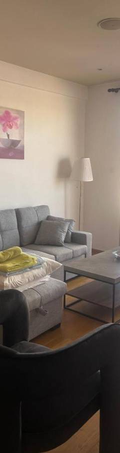 a living room with a couch and a table at Ithaki Phinikoudes Apartment No. 205 in Larnaka