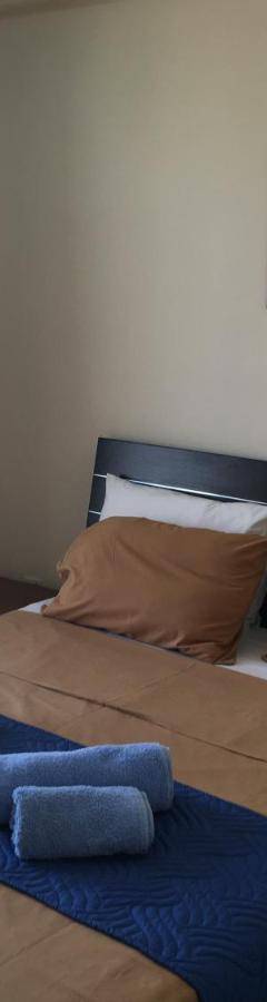 a bedroom with a large bed with blue towels on it at Ithaki Phinikoudes Apartment No. 205 in Larnaka