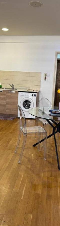 a kitchen with a table and chairs in a room at Ithaki Phinikoudes Apartment No. 205 in Larnaka