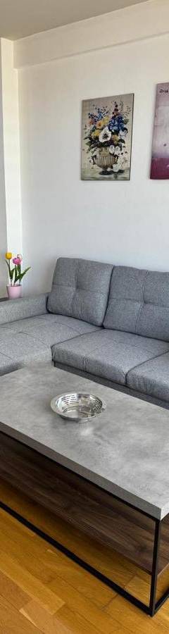 a living room with a couch and a coffee table at Ithaki Phinikoudes Apartment No. 205 in Larnaka