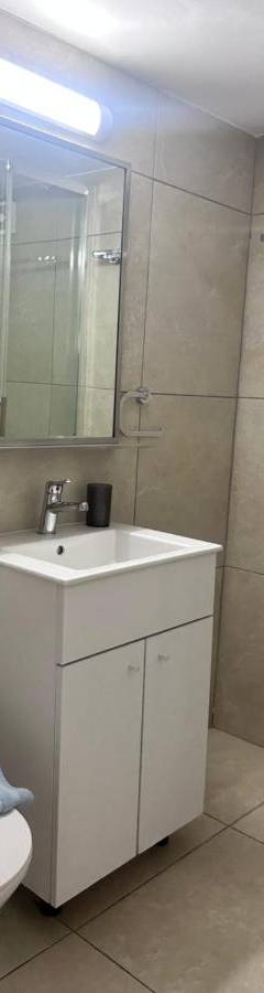a bathroom with a toilet and a sink and a shower at Alex Beach Apartment 203 in Larnaka