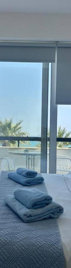 a bedroom with a bed with towels on it at Alex Beach Apartment 203 in Larnaka