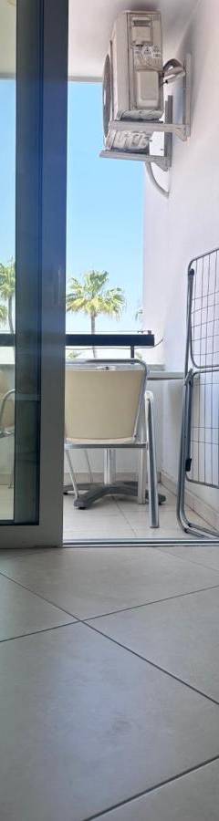 a room with a balcony with a view of the ocean at Alex Beach Apartment 203 in Larnaka