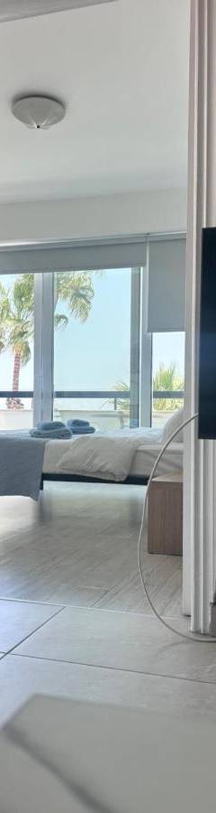 a living room with a television on a table at Alex Beach Apartment 203 in Larnaka