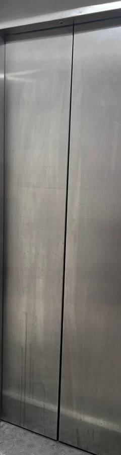 a elevator in a building with a metal door at Alex Beach Apartment 203 in Larnaka