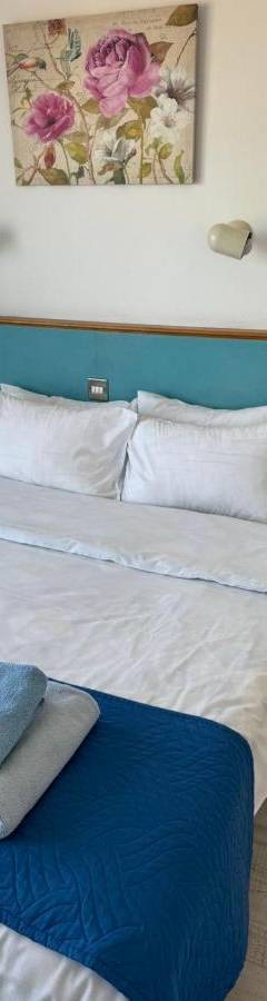 a bedroom with a large bed with towels on it at Alex Beach Apartment 203 in Larnaka