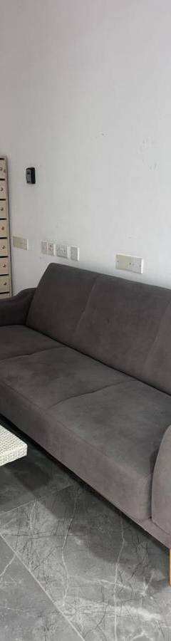 a living room with a couch and a coffee table at Alex Beach Apartment 203 in Larnaka