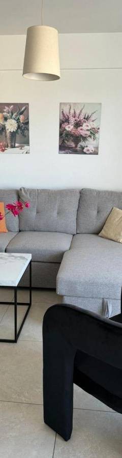 a living room with a couch and a table at Alex Beach Apartment 203 in Larnaka
