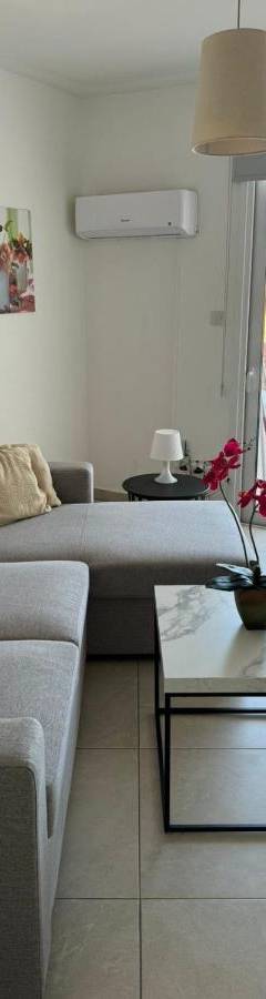 a living room with a couch and a table at Alex Beach Apartment 203 in Larnaka
