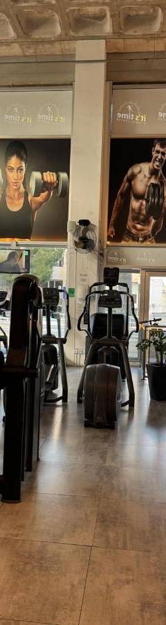 a gym with lots of equipment in a room at Raam Luxury Suites in Larnaka