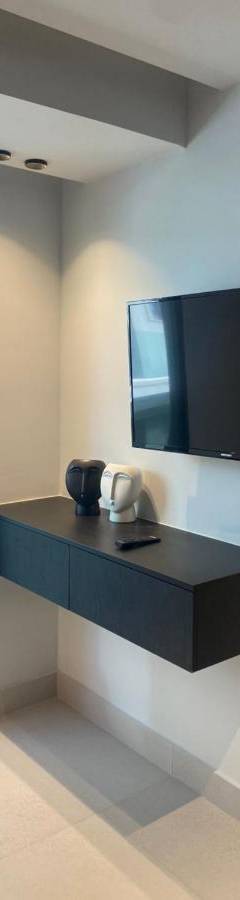 a room with a flat screen tv on a wall at Raam Luxury Suites in Larnaka