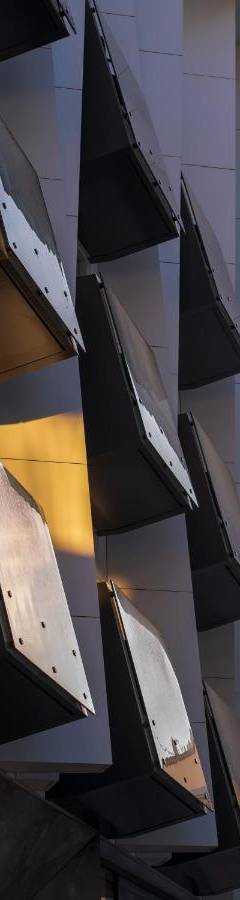 a building with a bunch of lights on the side of it at Raam Luxury Suites in Larnaka