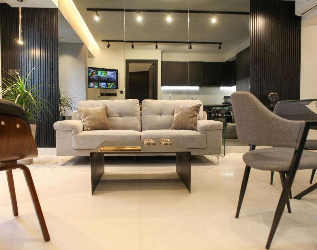 a living room with a couch and a table and chairs at Raam Luxury Suites in Larnaka