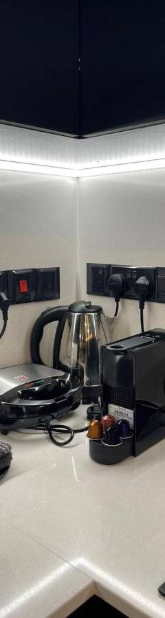 a kitchen counter with a blender and a phone on it at Raam Luxury Suites in Larnaka