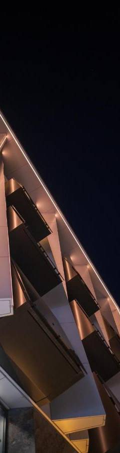a close up of a building with windows at night at Raam Luxury Suites in Larnaka