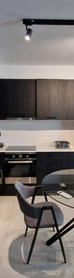 a kitchen with a table and chairs in a room at Raam Luxury Suites in Larnaka