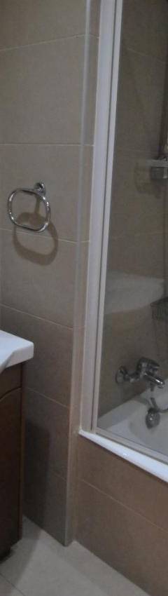 a bathroom with a sink and a shower and a tub at Ithaki Phinikoudes Apartment No. 102 in Larnaka