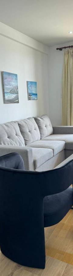 a living room with a couch and a table at Ithaki Phinikoudes Apartment No. 102 in Larnaka