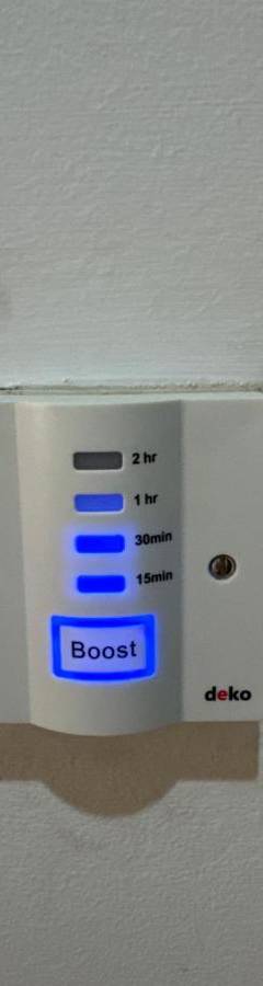an electrical outlet on a wall with the words boost at Ithaki Phinikoudes Apartment No. 102 in Larnaka