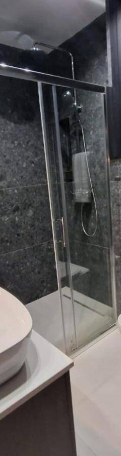 a bathroom with a toilet and a glass shower at Raam Luxury Suites in Larnaka