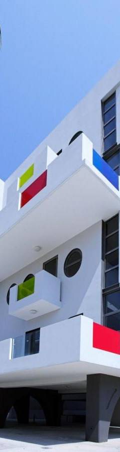 an image of a white building with a palm tree at Alex Residence in Larnaka