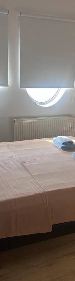 a bedroom with a bed with two towels on it at Alex Residence in Larnaka