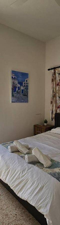 a bedroom with a bed and a large window at Ammos Beachfront Villa Paradise in Larnaca