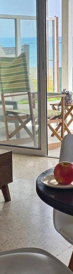 a living room with a table with glasses of orange juice at Ammos Beachfront Villa Paradise in Larnaca
