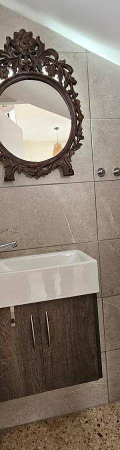a bathroom with a toilet and a sink and a mirror at Ammos Beachfront Villa Paradise in Larnaca