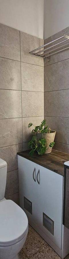 a bathroom with a toilet and a sink and a mirror at Ammos Beachfront Villa Paradise in Larnaca