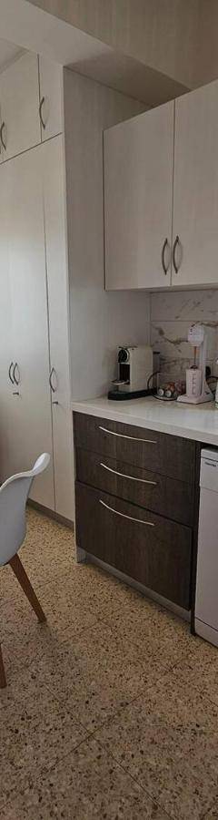 a kitchen with a table and chairs and a table and a sink at Ammos Beachfront Villa Paradise in Larnaca