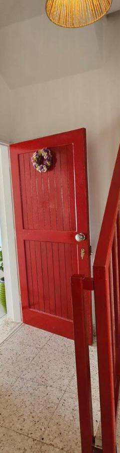 a stairway with a red door and a red door sidx sidx sidx at Ammos Beachfront Villa Paradise in Larnaca