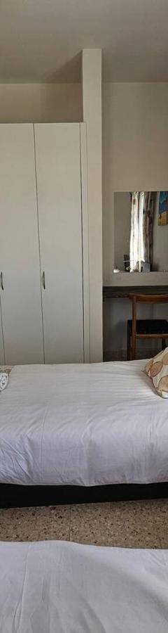 a bedroom with two beds and a window at Ammos Beachfront Villa Paradise in Larnaca
